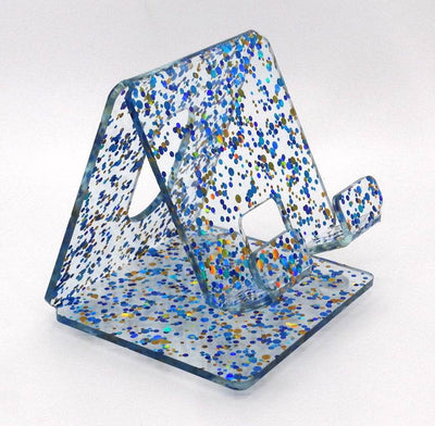 Global Phone Stand in Blue confetti acrylic design, fits most smartphones, durable and easy to clean.
