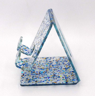 Global Phone Stand in Blue confetti acrylic design, fits most smartphones, durable and easy to clean.