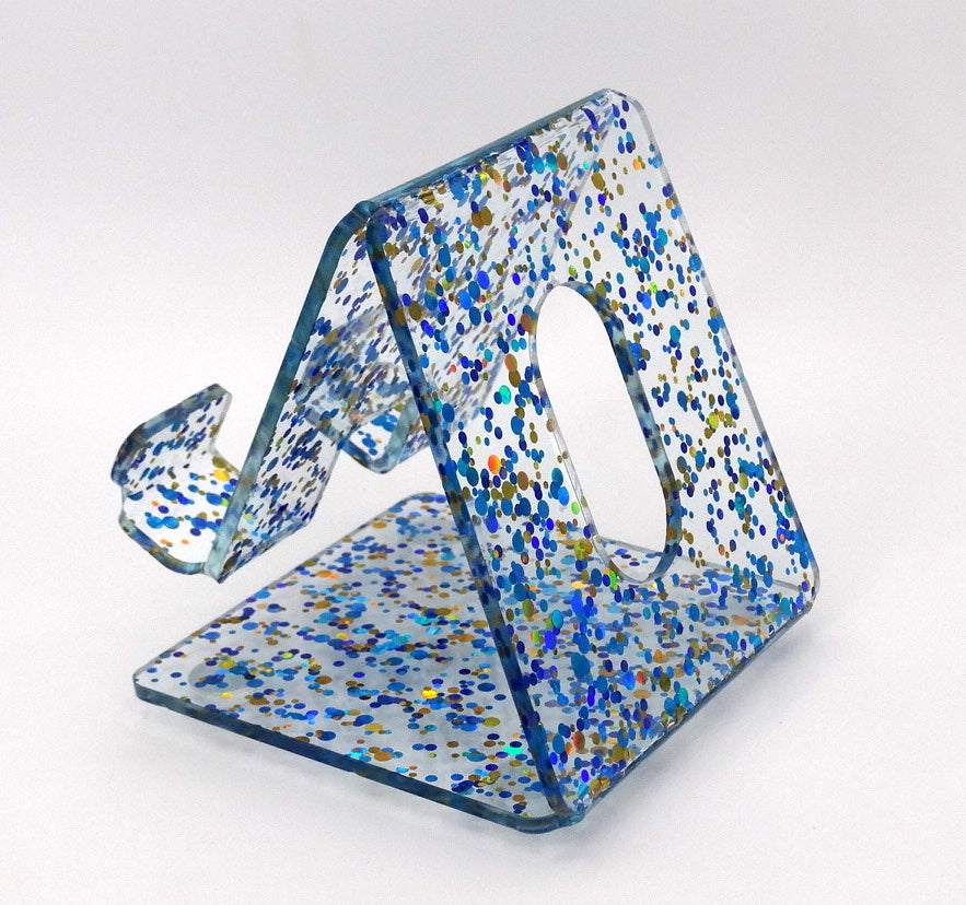 Global Phone Stand in Blue confetti acrylic design, fits most smartphones, durable and easy to clean.