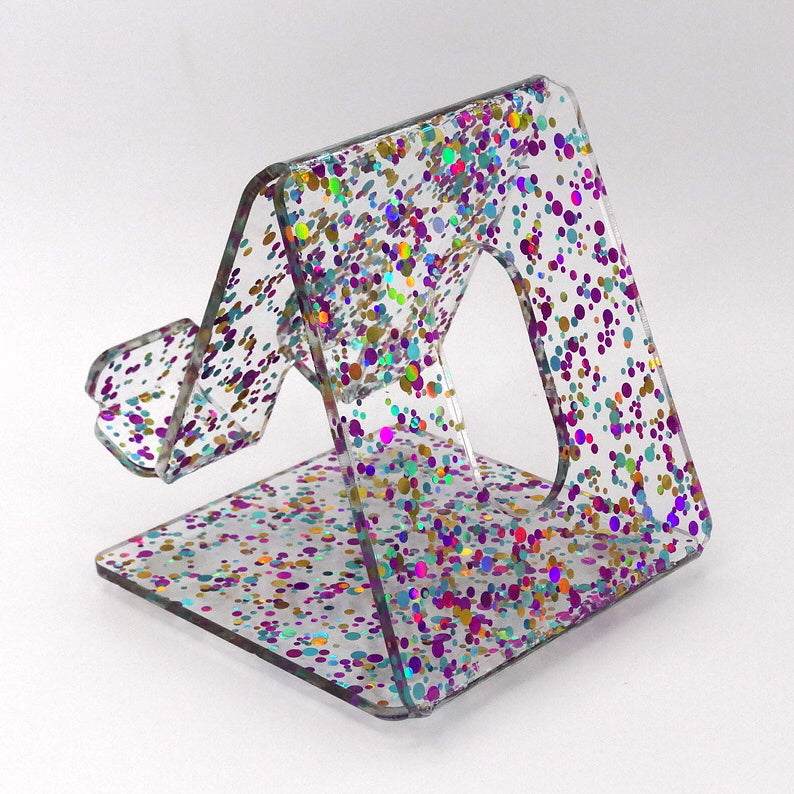 Global Phone Stand Multi Colored confetti-patterned acrylic design, fits most smartphones, durable and easy to maintain.
