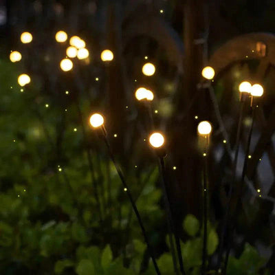 Solar LED Butterfly and Bee Firefly Garden Lights with colorful glowing butterflies on stakes for outdoor decoration at night