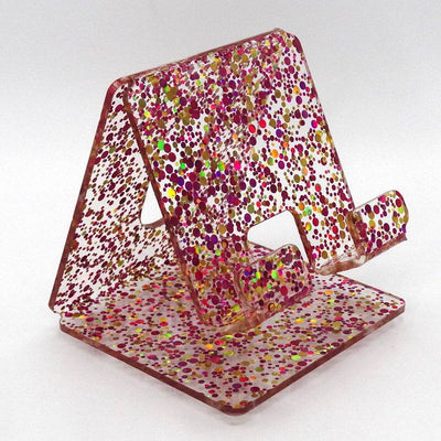 Global Phone Stand in Red confetti acrylic design, fits most smartphones, durable and easy to clean.
