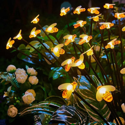 Solar LED Butterfly and Bee Firefly Garden Lights with colorful glowing butterflies on stakes for outdoor decoration at night